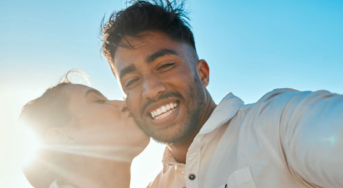 Woman kissing her husband's cheek