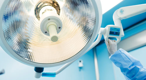 Surgeon moving a surgical light
