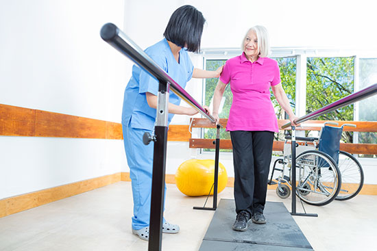 nurse and women working on physical therapy, walking 