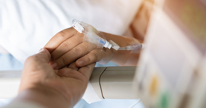 Doctor holding patient's hand